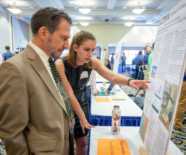 michael accorsi with a female student presenting her poster